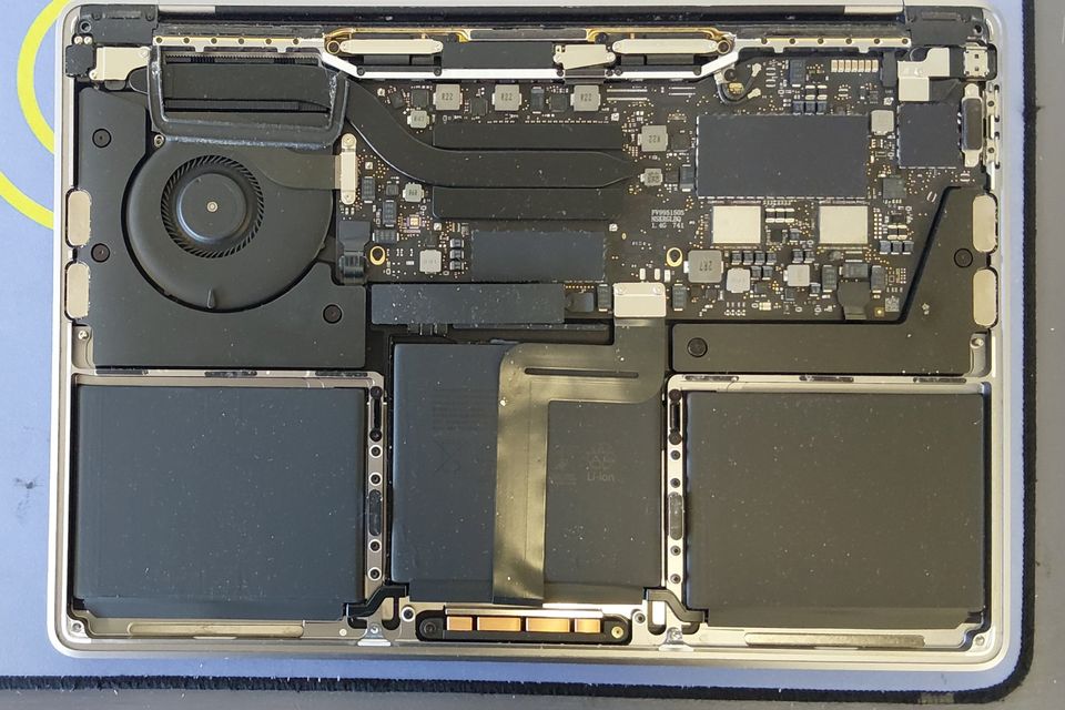 MacBook Pro opened up on our repair bench, showing the battery, fan and logic board – MacBook repair Christchurch